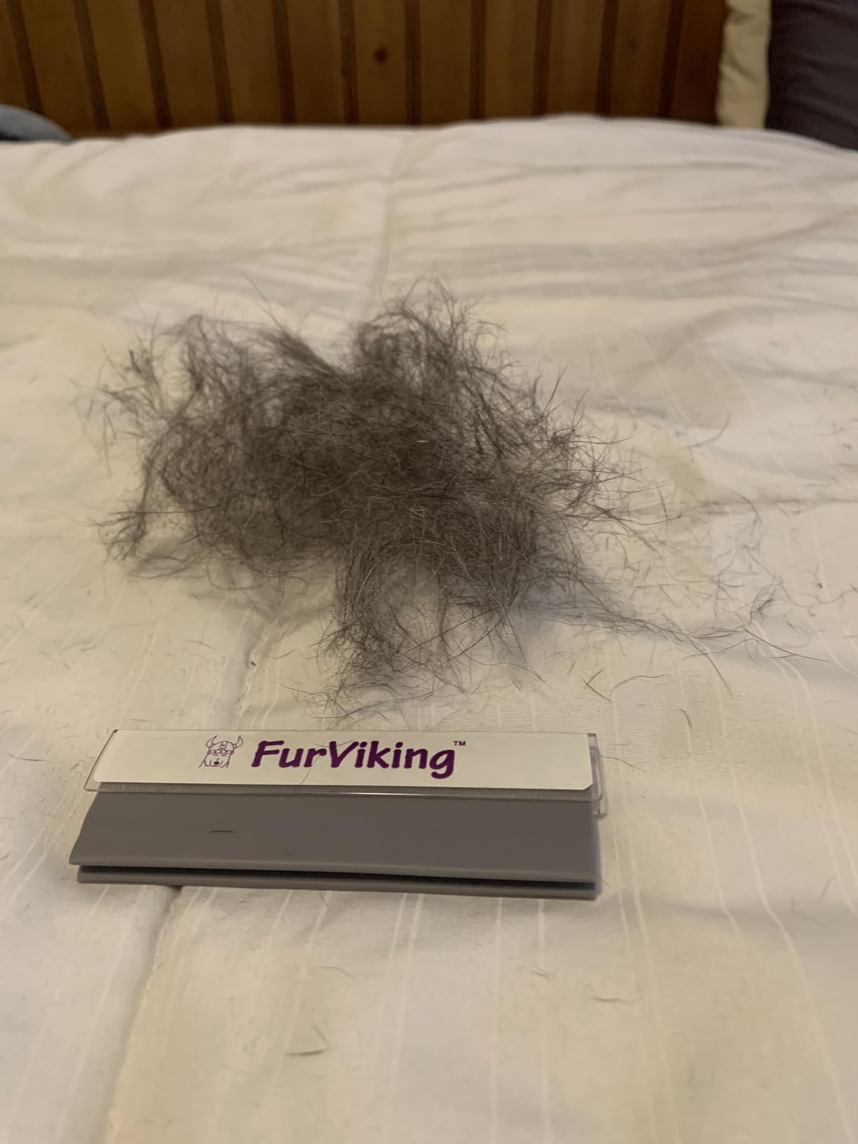 FurViking pet removal tool infront of a big lump of hair